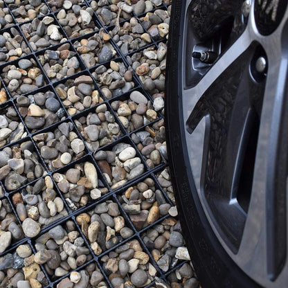 Close-up of a car tire on a gravel surface reinforced with IBRAN grids